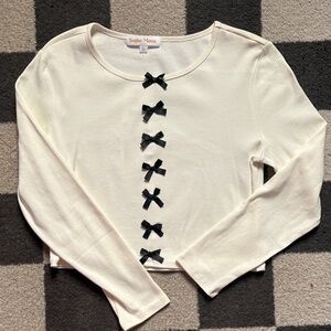 Elegant Cream Top with Black Bows